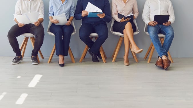 four people sitting on chair for interview