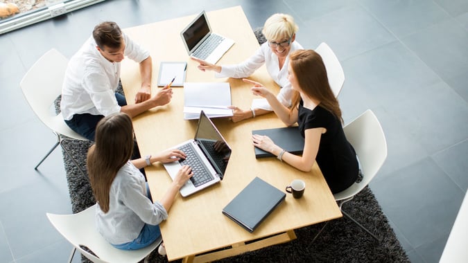 people working on computers at desk