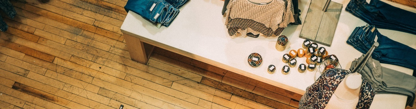 picture of a retail shop with clothes displayed on a table